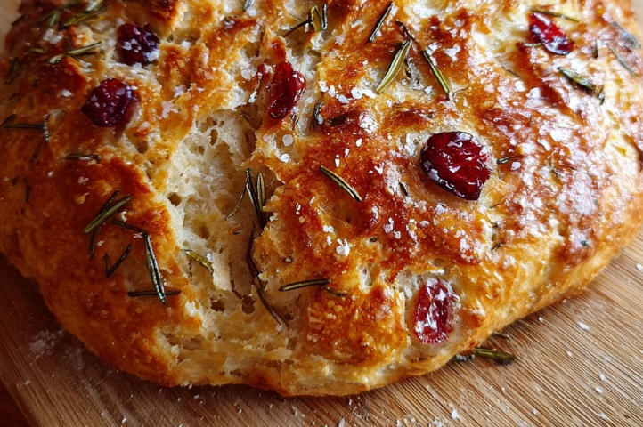 No-Knead Rosemary Cranberry Bread with Olive Oil & Sea Salt Ingredients: 3 cups (360 g) all-purpose flour 1 1/4 teaspoons (7 g) salt 1/2 teaspoon (2 g) instant yeast 1 1/2 cups (360 ml) warm water 1/2 cup (70 g) dried cranberries 2 teaspoons (1 g) fresh rosemary, chopped 2 tablespoons (30 ml) olive oil, plus extra for drizzling Sea salt, for sprinkling Directions: In a large bowl, combine flour, salt, and yeast. Stir in water until a sticky dough forms. Fold in cranberries and rosemary. Cover the bowl with plastic wrap or a clean kitchen towel. Let the dough rise at room temperature for 12–18 hours, until bubbly and doubled in size. Preheat the oven to 450°F (230°C). Place a Dutch oven or heavy oven-safe pot inside to heat for 30 minutes. Carefully transfer the dough into the hot pot. Drizzle with olive oil and sprinkle with sea salt. Cover with the lid and bake for 30 minutes. Remove the lid and bake an additional 15 minutes, until the crust is golden and crisp. Cool on a wire rack before slicing. Prep Time: 15 minutes Rising Time: 12–18 hours Cooking Time: 45 minutes Total Time: 13–18 hours 45 minutes Kcal: 220 per slice Servings: 8